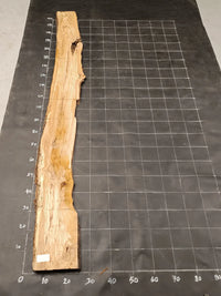 Planche bois d'olivier rabotée 2 cm à bord naturel, 185×30 cm, réf P23, sur tapis quadrillé 10 cm — verso